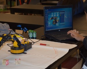 Advanced Robotics students, operating their robotic arm.