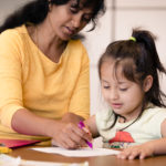 Extended School Year student enjoys working on project with her aid