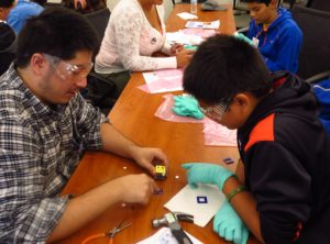 engineer works with CMS student on fidget cube