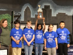 SMS Science Bowl Team holds third place trophy in the air