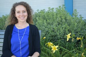 michelle maginot board member sits on bench out front of san miguel elementary