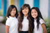 three girls with their arms wrapped around each other