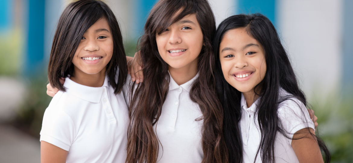 three girls with their arms wrapped around each other