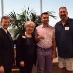 Adam Mody of KIDS donates check