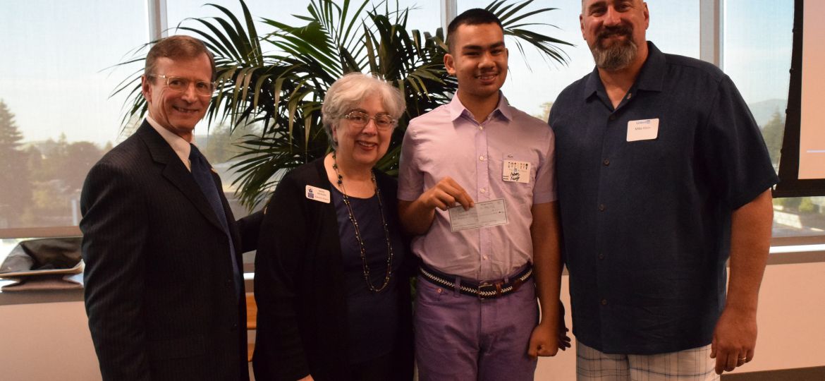 Adam Mody of KIDS donates check