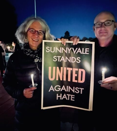 couple holds sign that reads Sunnyvale stands united against hate
