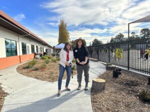 Bishop Principal Tara Lubrano and parent Eileen Bloom stand in the school garden